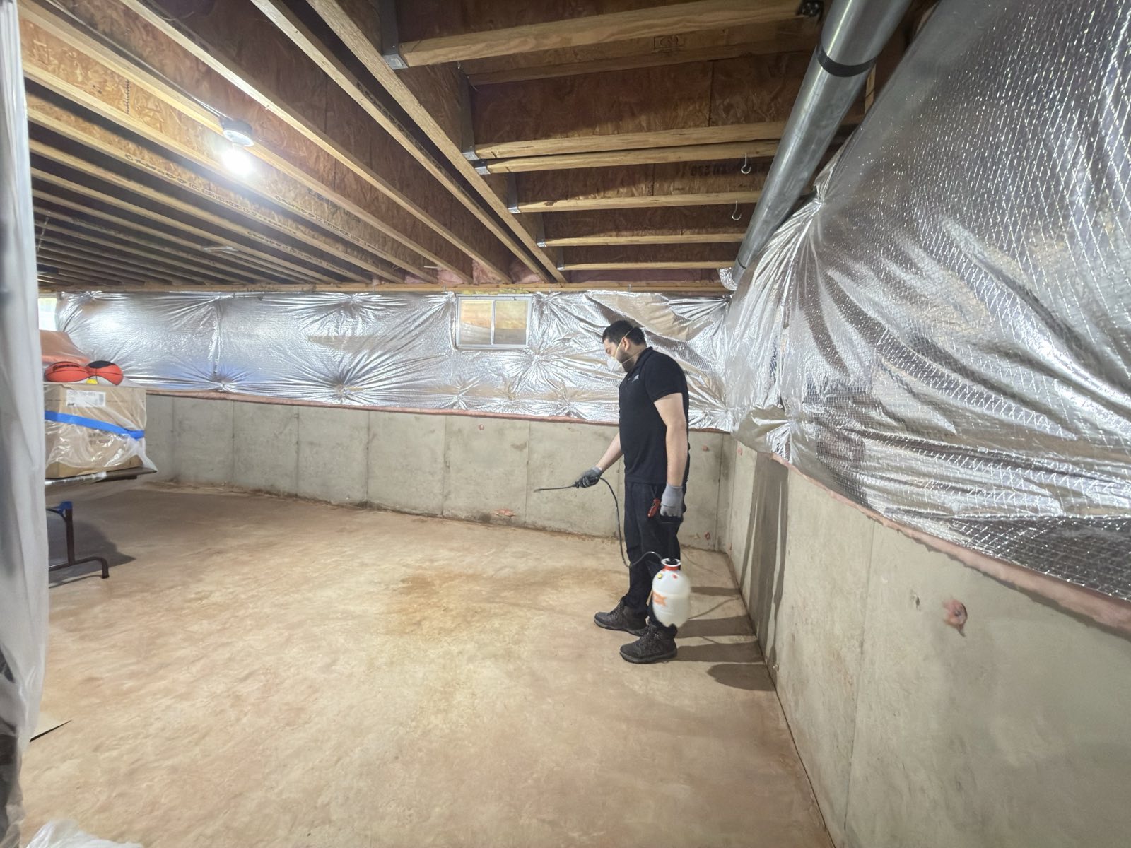 Restoration crew applying antimicrobial treatment during water damage mitigation